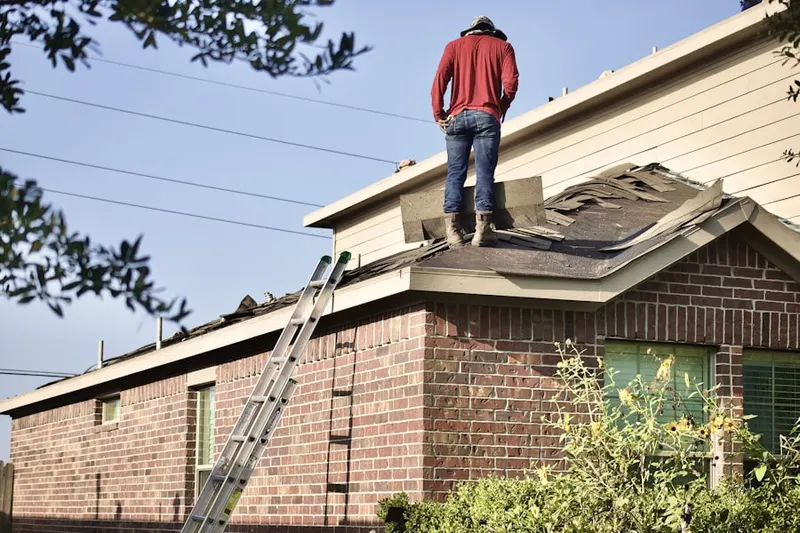 Professional roofer working on a residential roof in Jericho